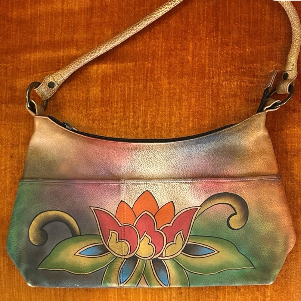 Anuschka hand-painted genuine leather bag featuring floral lotus artwork.